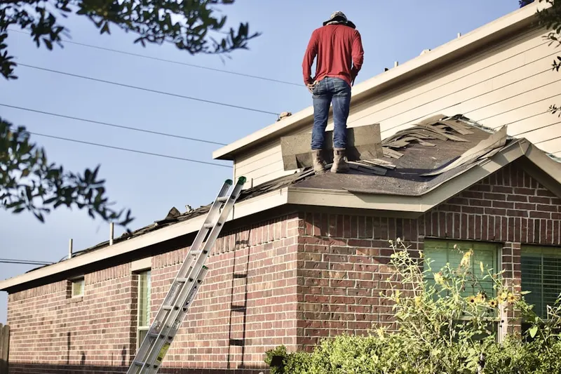 Professional roofer working on a residential roof in English
